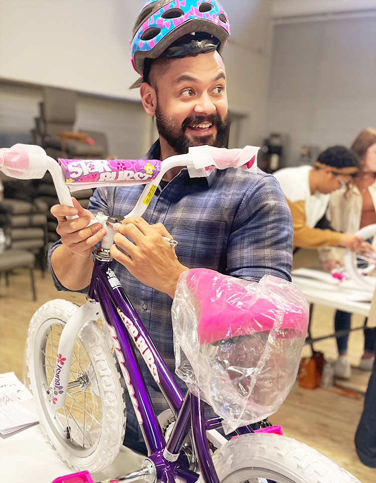 Cam building bikes at the Midan holiday party