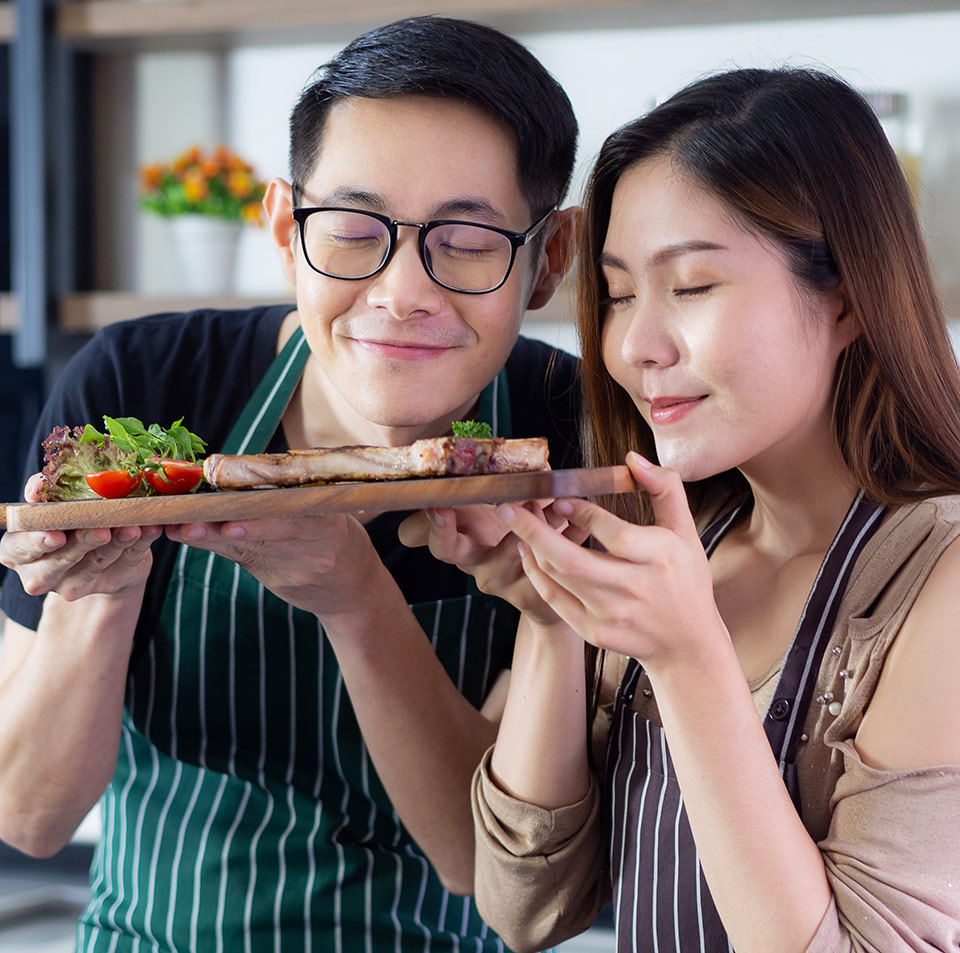 Asian couple smelling food