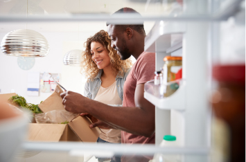 Couple looking through their meal kit delivery