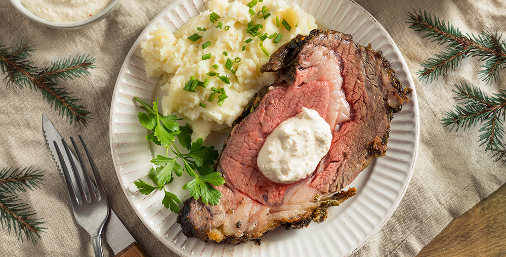 Perfectly cooked steak on a plate with mashed potatoe sides