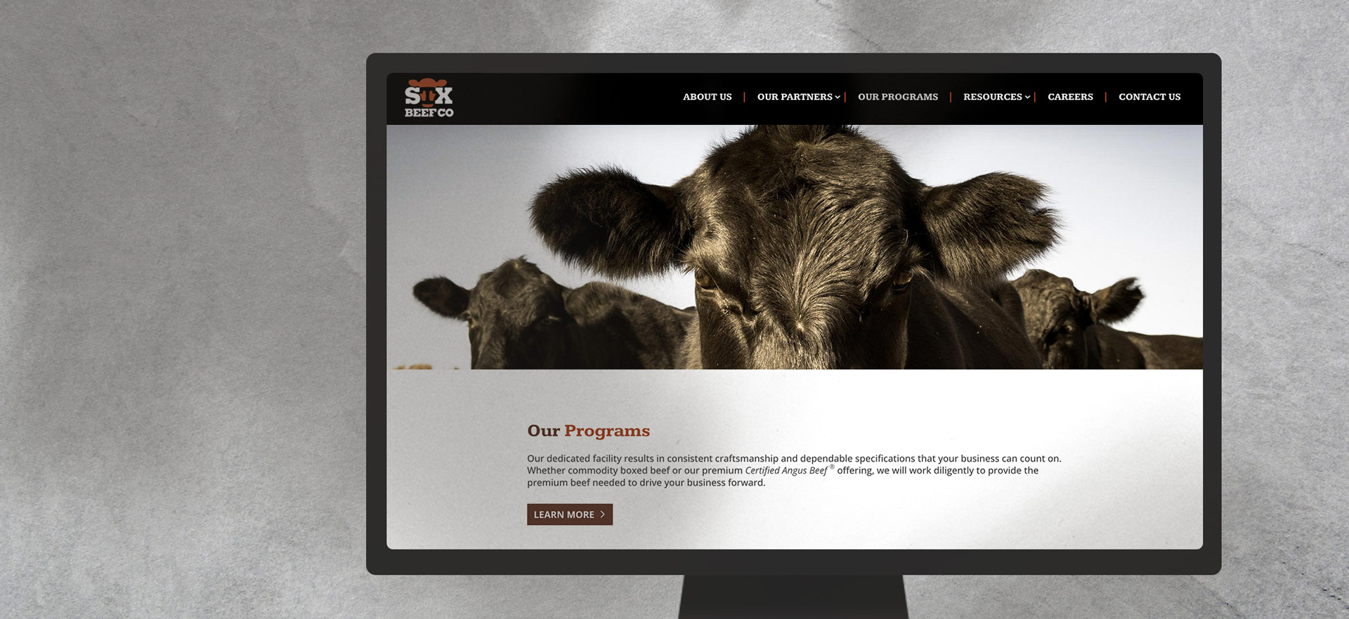 STX Beef website mockup on desktop monitor