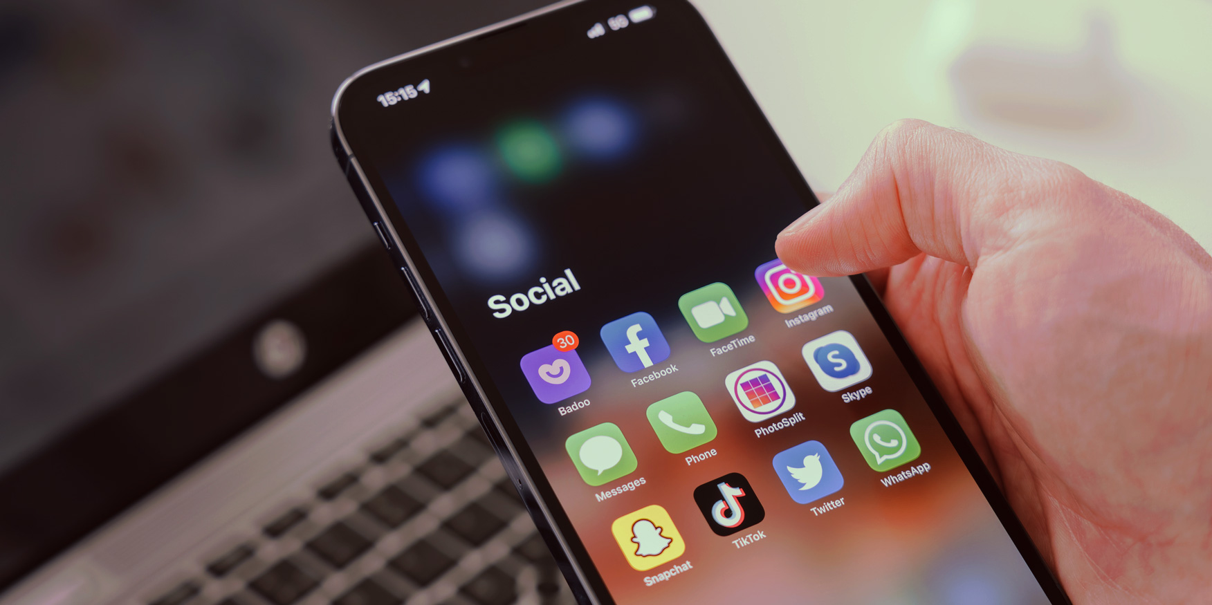 A smartphone displays multiple social media app icons