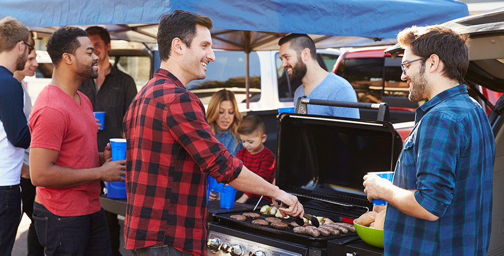 Tailgating at a sporting event, cooking on a portable grill