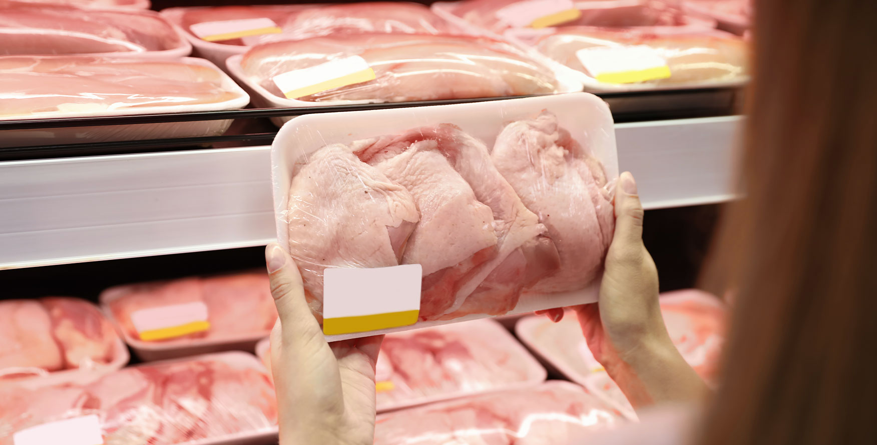 Meat consumer holding case ready packaged chicken