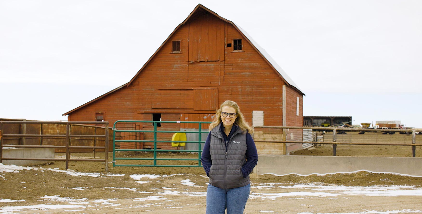 Midan's Danette Amstein standing in front of her family farm