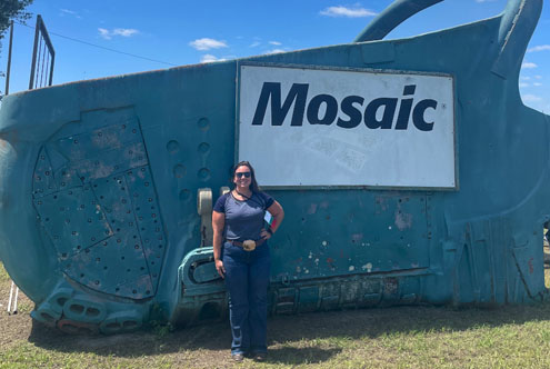Erica Prescott posing in front of the Mosaic Four Corners Mine