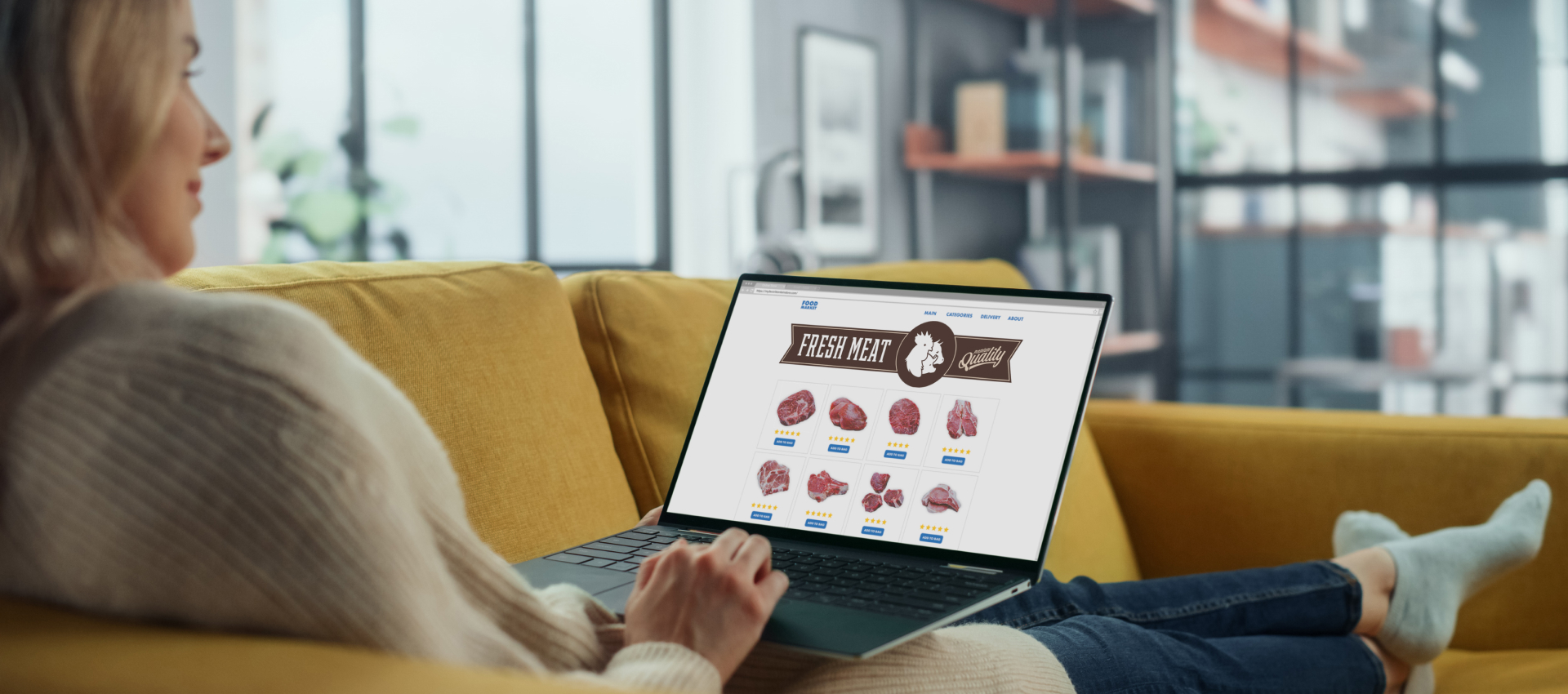 Woman sitting on couch looking at fresh meat products on a laptop