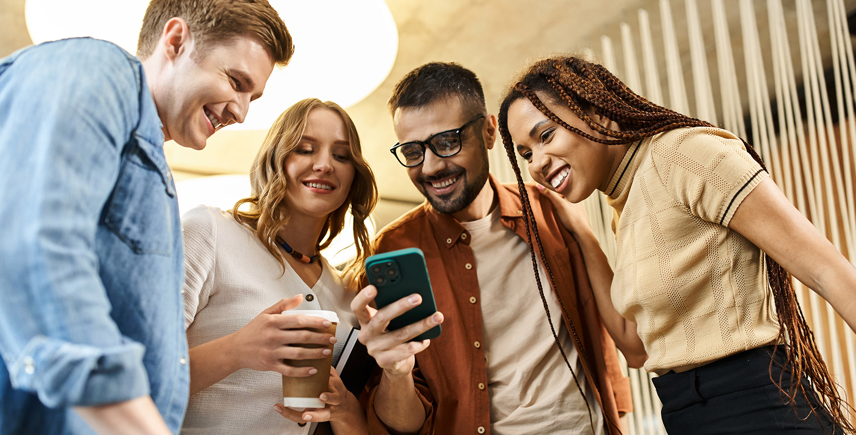 young people gathered around a phone