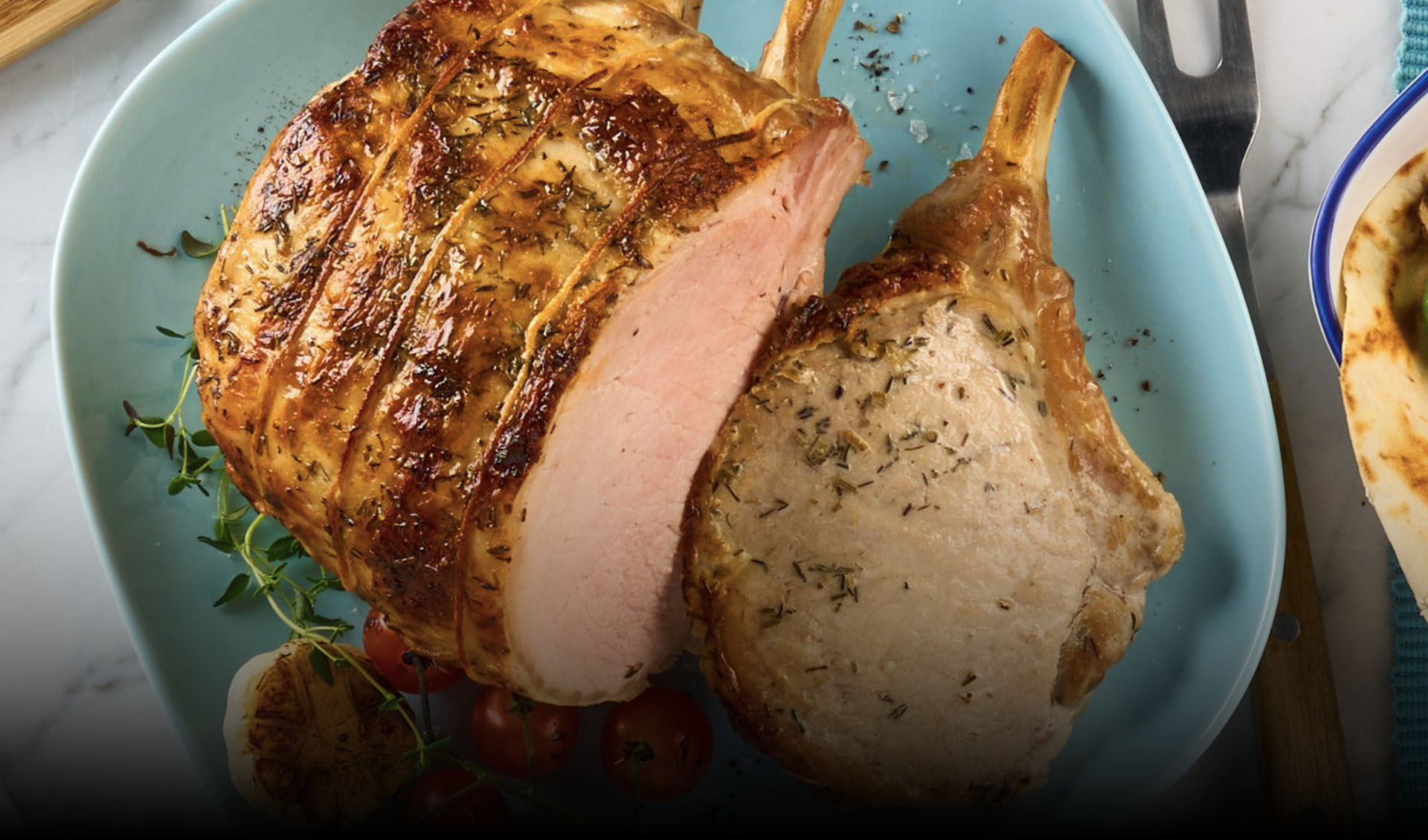 A plated Bone-In Frenched Pork Loin Roast