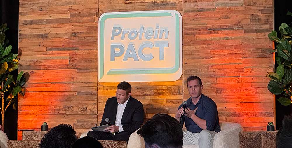 Dr. Anthony Chaffee and Dr. Dustin Moore debate on stage at the 2025 protein pact summit