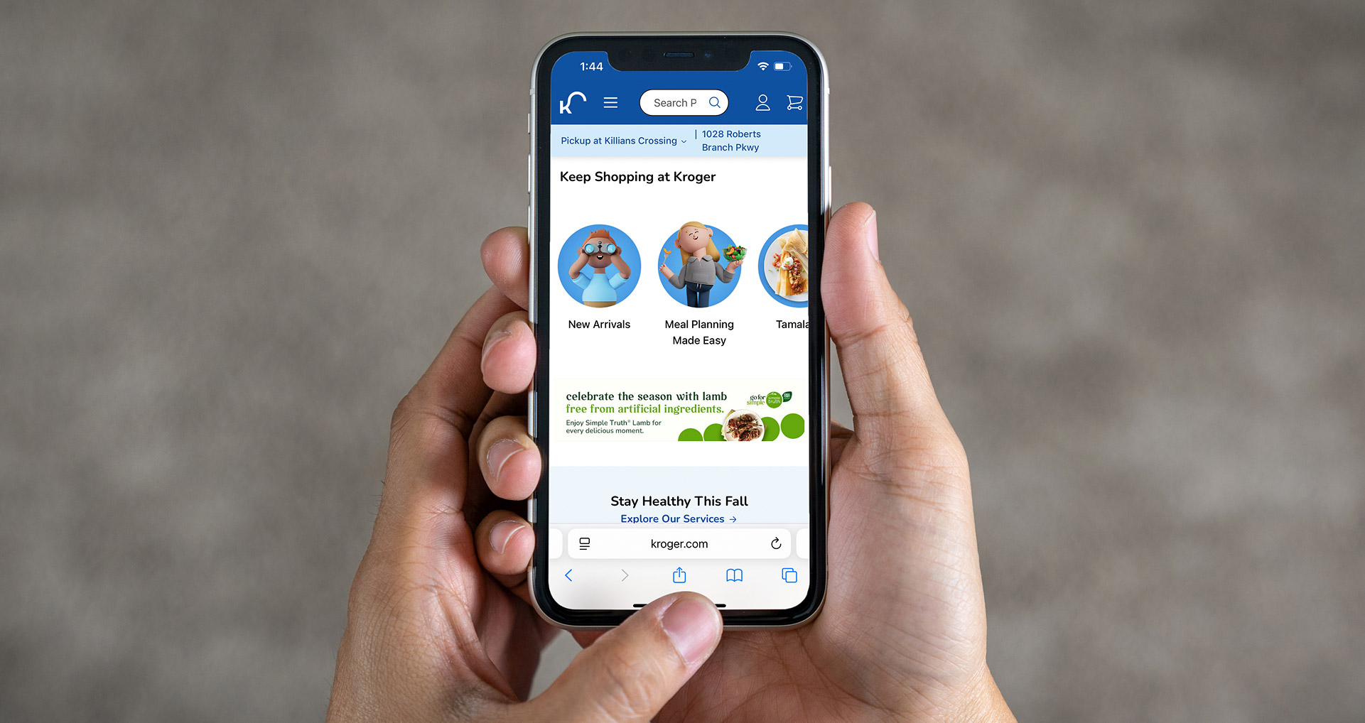 Hands holding a cell phone displaying a mobile ad